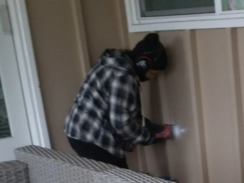 Professional electrician installing an exterior outlet in Denison